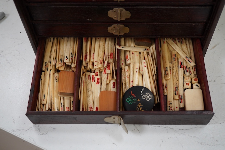 A Chinese bone and bamboo Mah-Jong set, 24cm wide